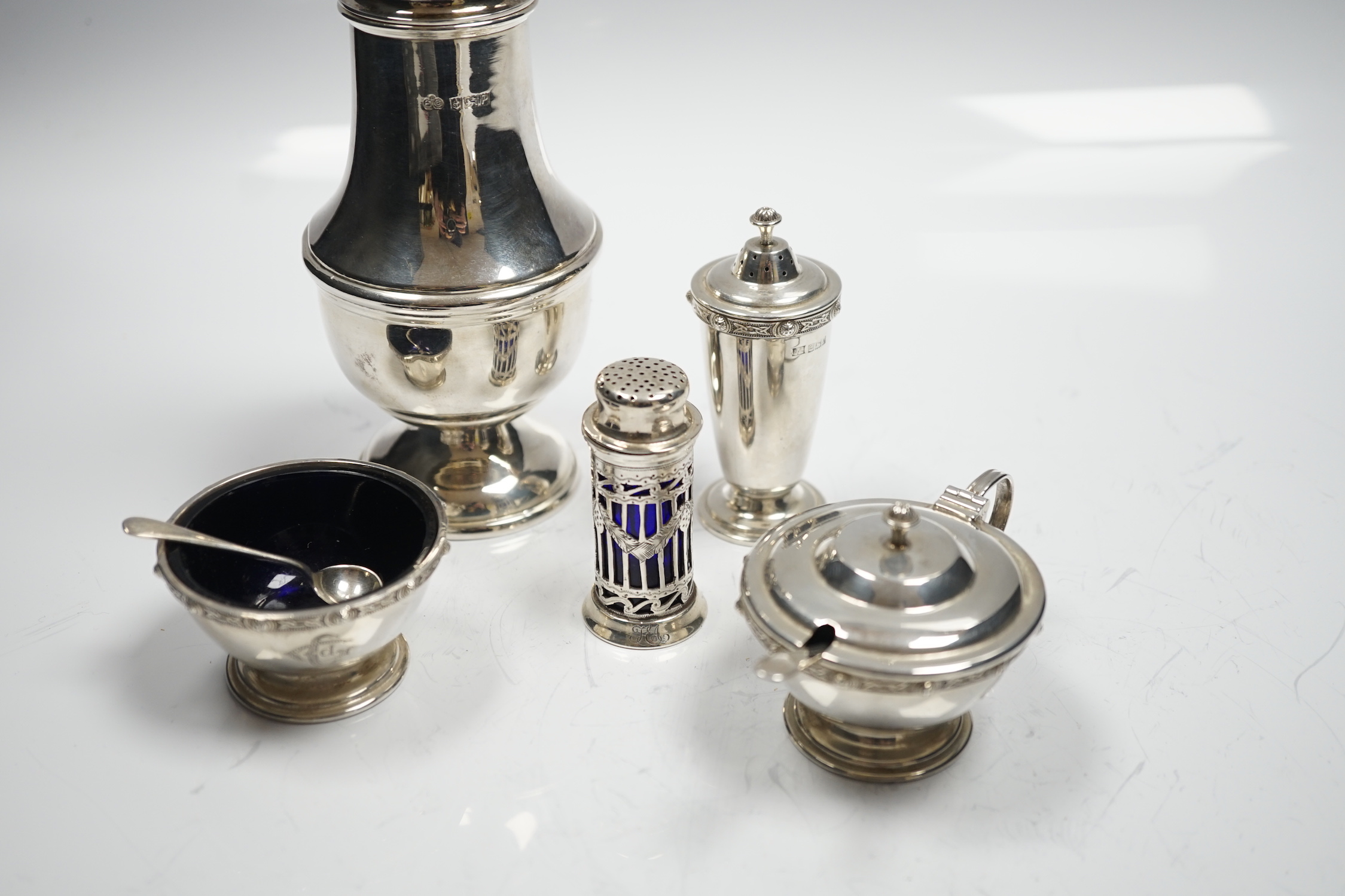 A modern silver baluster sugar caster by Elkington & Co and four assorted silver condiments.